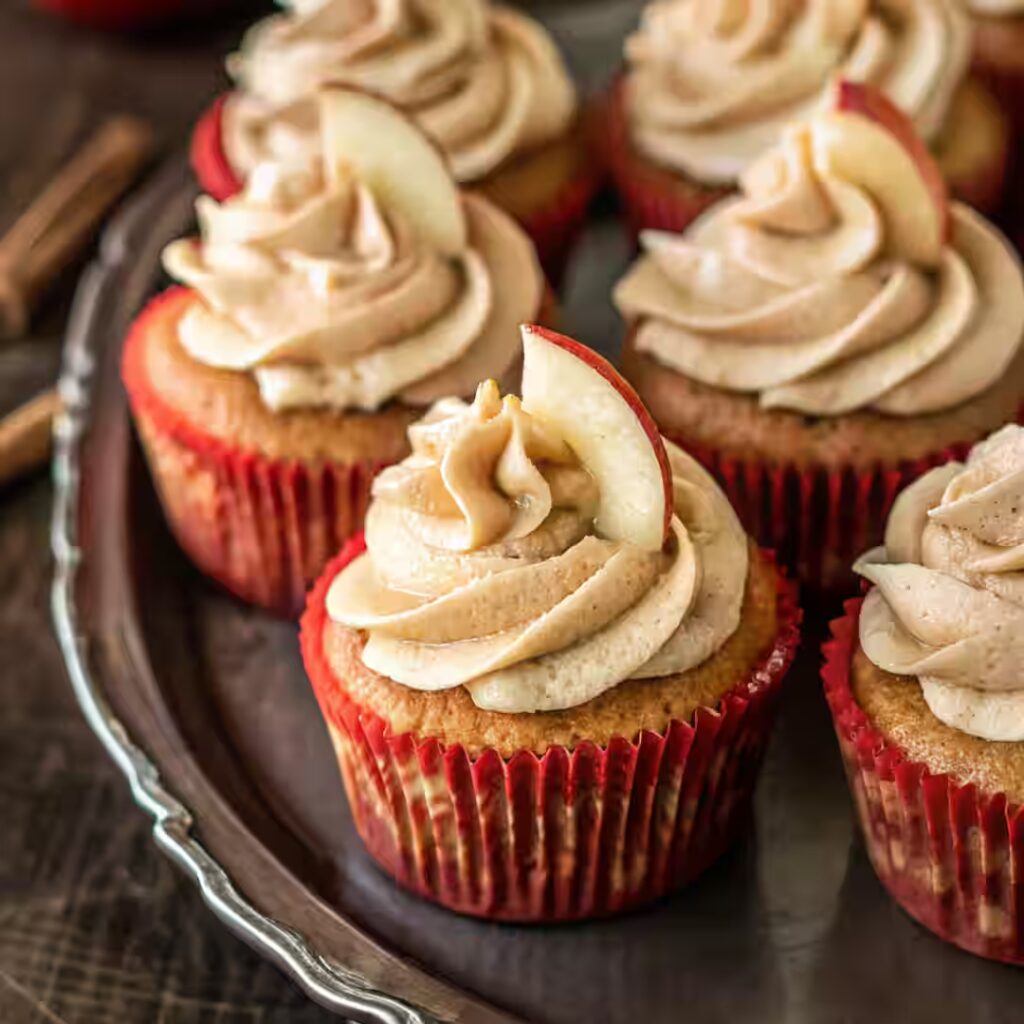 apple cider cupcakes with cinnamon buttercream frosting and apple slice garnish