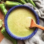Hatch Chile Green Sauce in blue bowl with wooden spoon