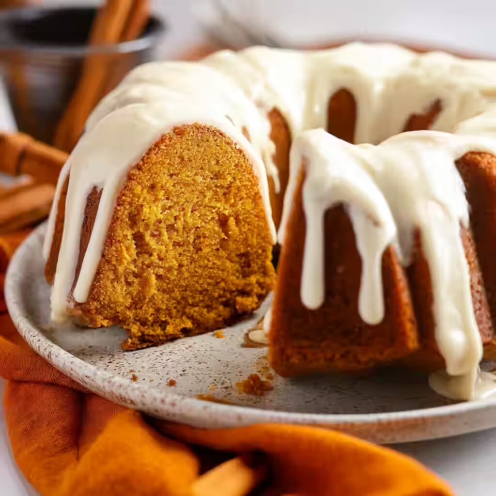 Pumpkin Bundt Cake with cream cheese glaze on a plate