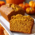 Freshly baked sour cream pumpkin bread sliced on a white plate