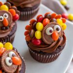 Turkey cupcakes decorated with Reese’s Pieces feathers and candy eyes